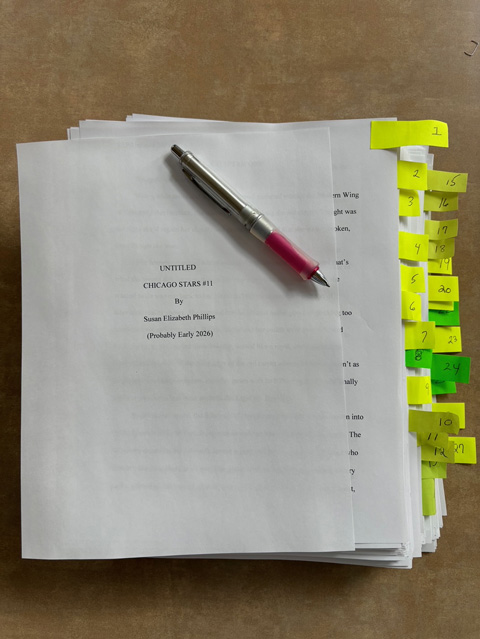 photo of manuscript filled with flags for edits