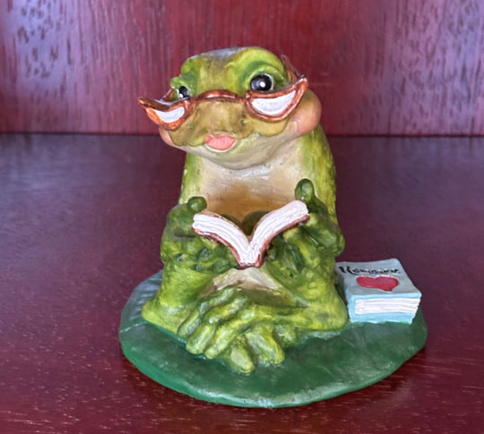 photo: statue of frog with book